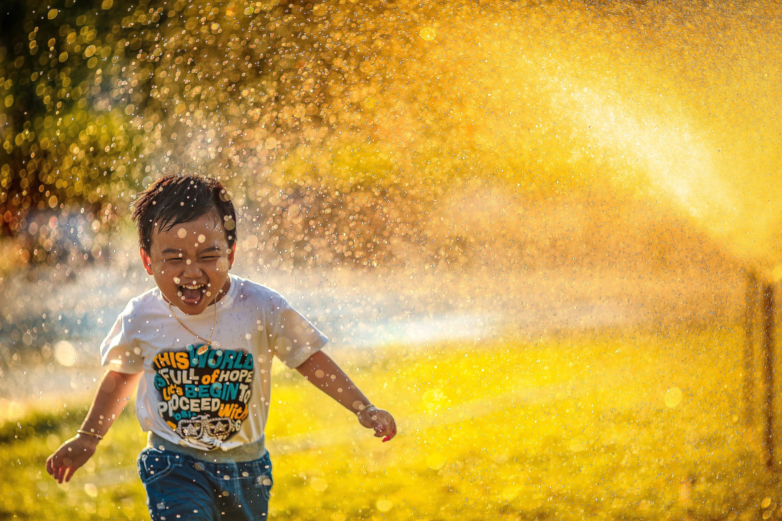 Picture of kid laughing running through water